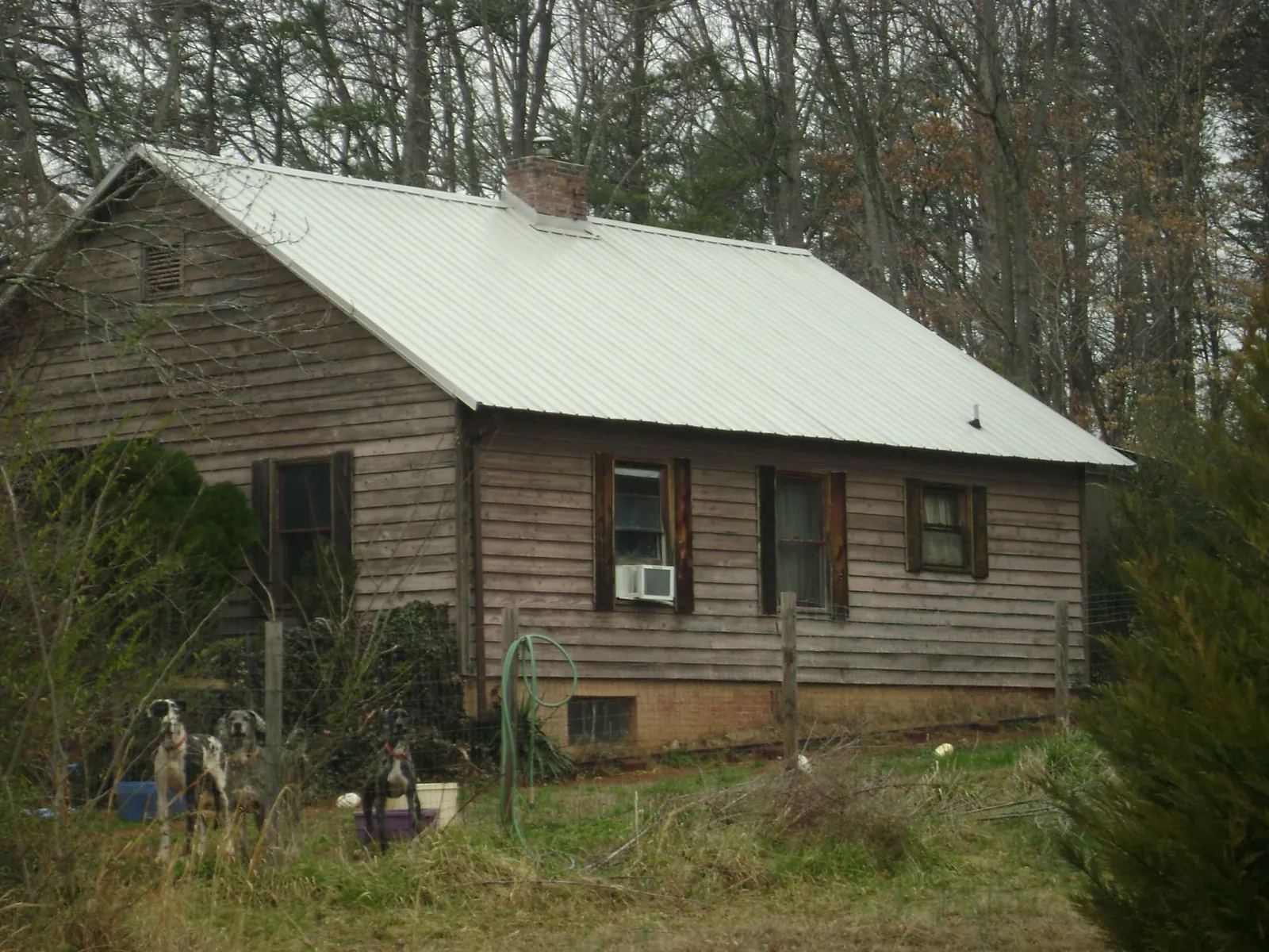 White metal roof on an old wood sided farmhouse, from a Metal Roof Installation job in Northampton