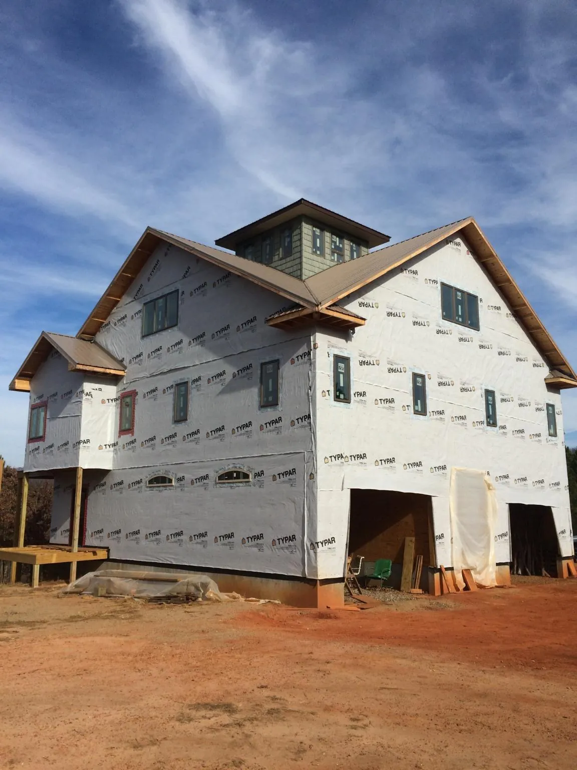 New two story house under construction with a cupola and gabled roofs in Northampton